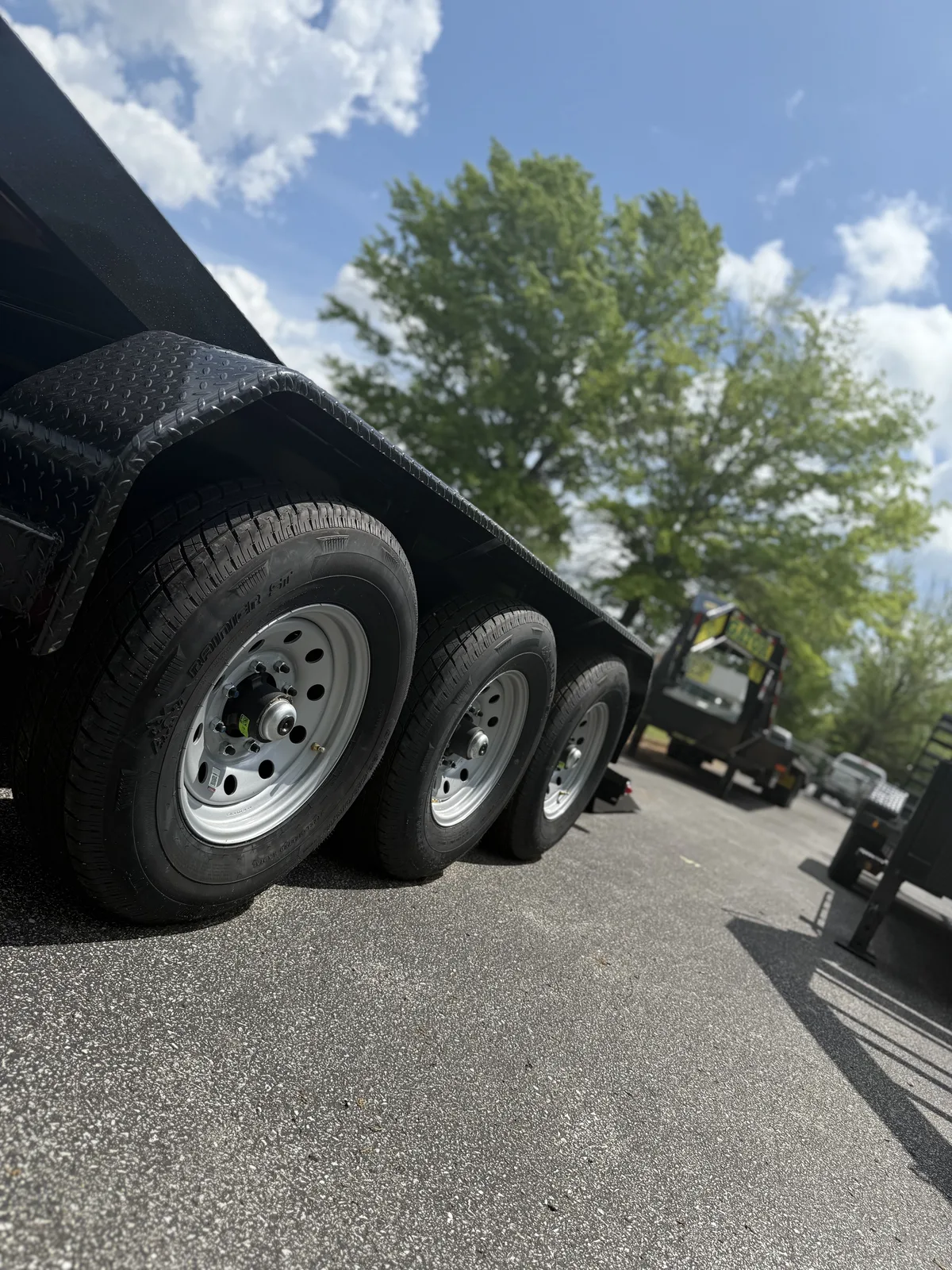 Row of Gatormade triple-axle trailers on the factory lot
